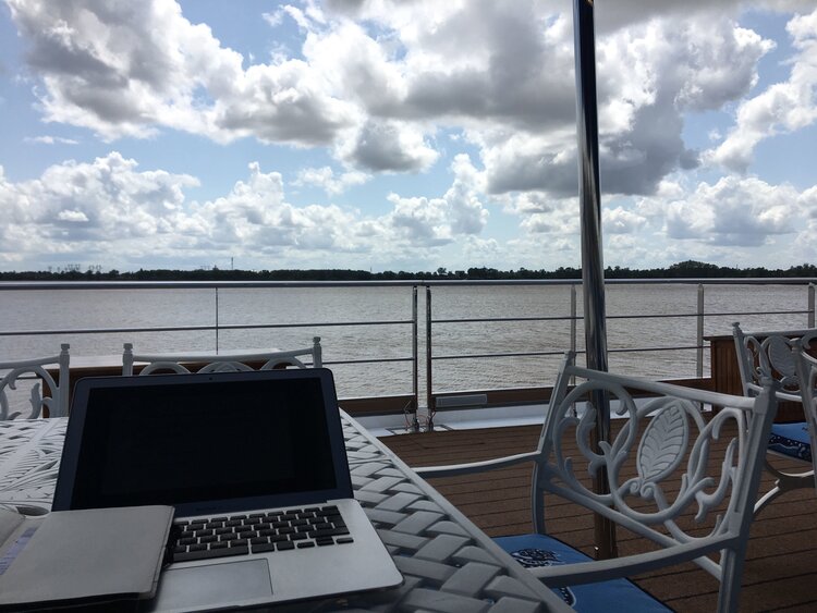 Photograph of Damian working from the sun deck